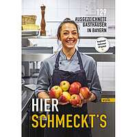 Buch-Cover von „Hier schmeckt's“, darauf eine lächelnde Köchin mit Äpfeln in der Hand.